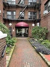 property entrance featuring brick siding