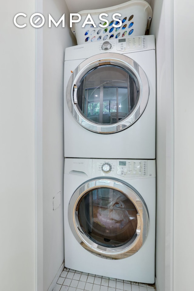 344 W 23rd St Unit 1E, New York City, NY 10011 - laundry area with stacked washer / drying machine and light tile patterned flooring