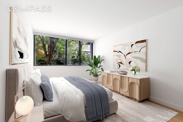 344 W 23rd St Unit 1E, New York City, NY 10011 - bedroom featuring baseboards and light wood-style flooring