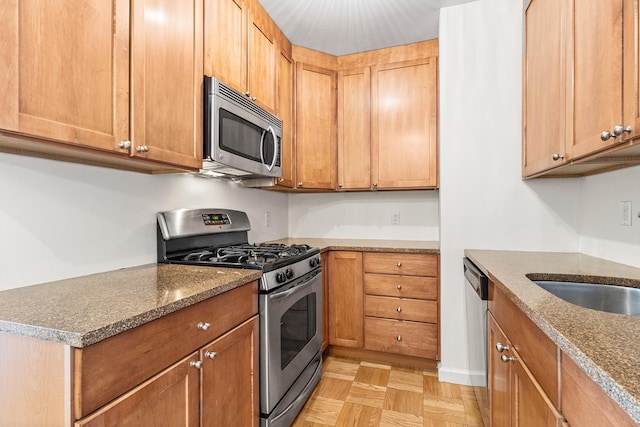 303 E 57th St Unit 6F, New York City, NY 10022 - kitchen with stainless steel appliances, dark stone counters, and a sink