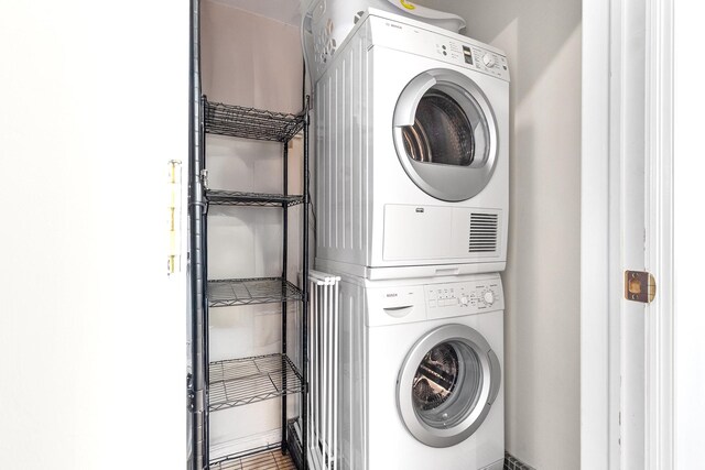 303 E 57th St Unit 6F, New York City, NY 10022 - washroom with stacked washing machine and dryer