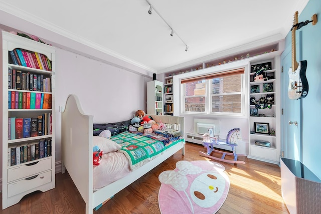 446 E 86th St Unit 7Ef, New York City, NY 10028 - bedroom featuring rail lighting, ornamental molding, and wood finished floors