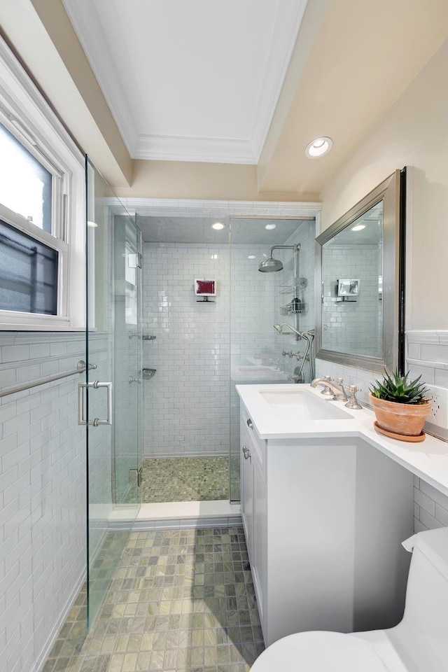 446 E 86th St Unit 7Ef, New York City, NY 10028 - bathroom with crown molding, toilet, vanity, tile walls, and a stall shower