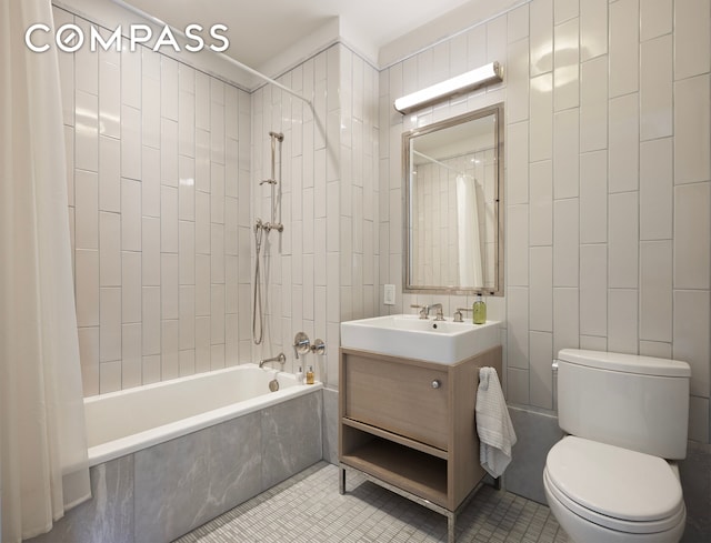 bathroom featuring toilet, shower / bath combo, vanity, tile patterned floors, and tile walls
