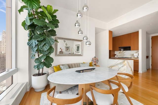 15 E 30th St Unit 21C, New York City, NY 10016 - dining area featuring light wood-style floors and baseboards