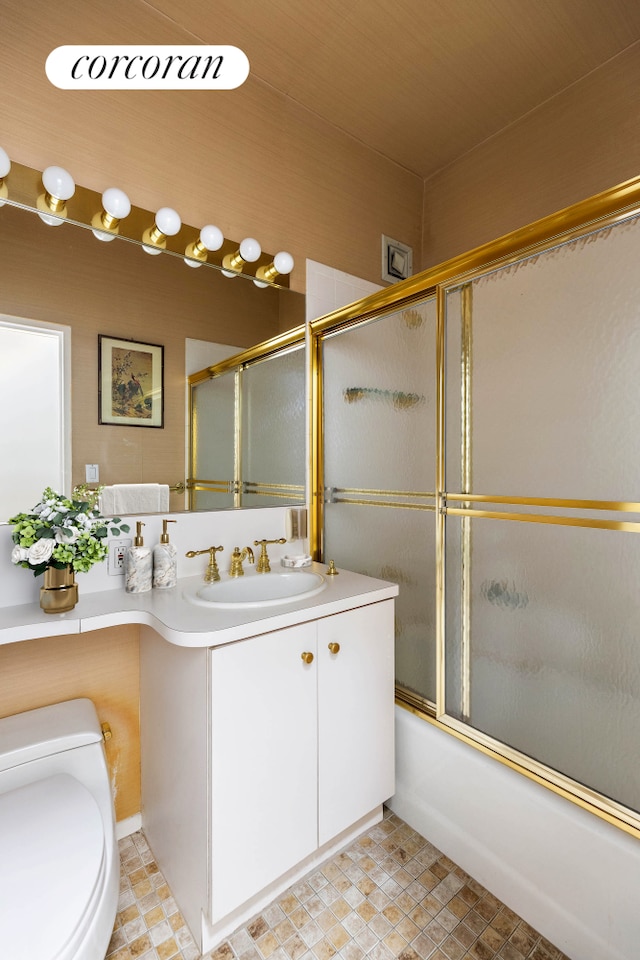full bathroom with toilet, vanity, and shower / bath combination with glass door
