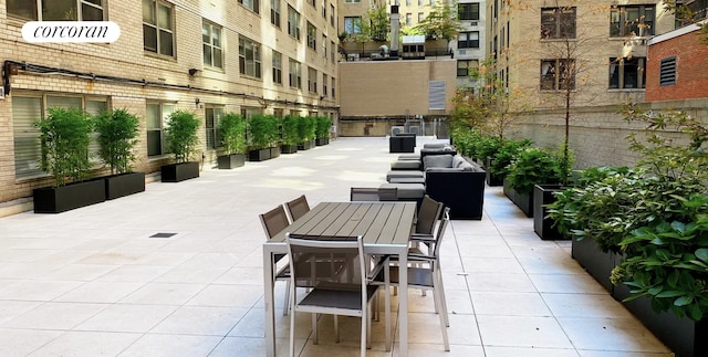 view of home's community with a patio and outdoor dining area