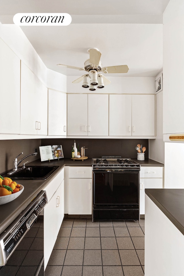 kitchen featuring black appliances, a sink, dark countertops, and white cabinets