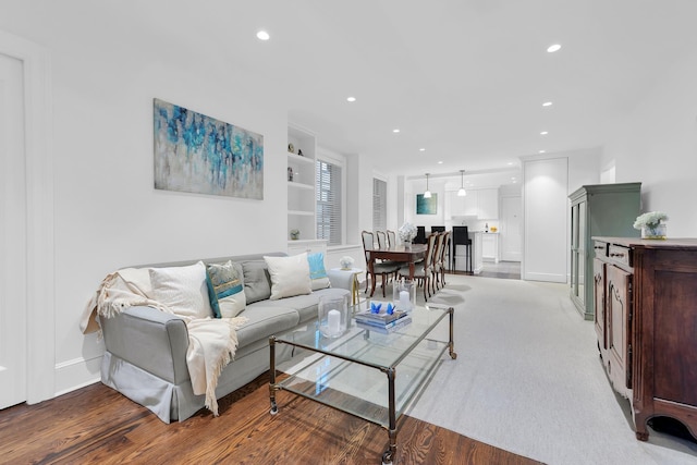 325 W 86th St Unit 7B, New York City, NY 10024 - living room with built in shelves, recessed lighting, baseboards, and wood finished floors