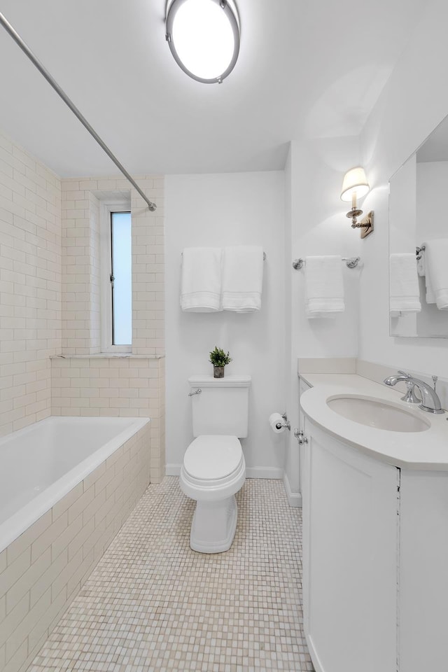 325 W 86th St Unit 7B, New York City, NY 10024 - bathroom featuring toilet, vanity, tiled shower / bath, tile patterned flooring, and baseboards