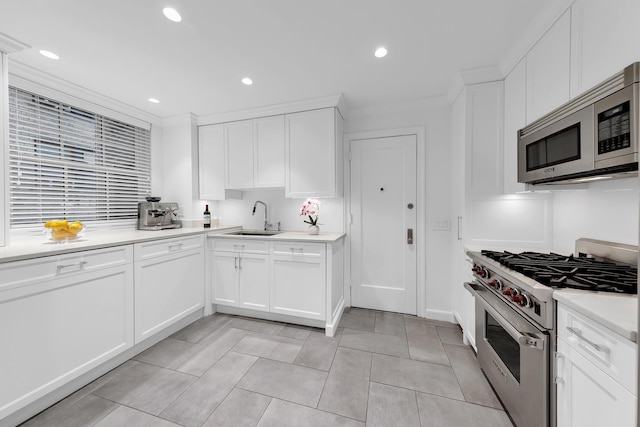 325 W 86th St Unit 7B, New York City, NY 10024 - kitchen featuring appliances with stainless steel finishes, a sink, light countertops, recessed lighting, and crown molding