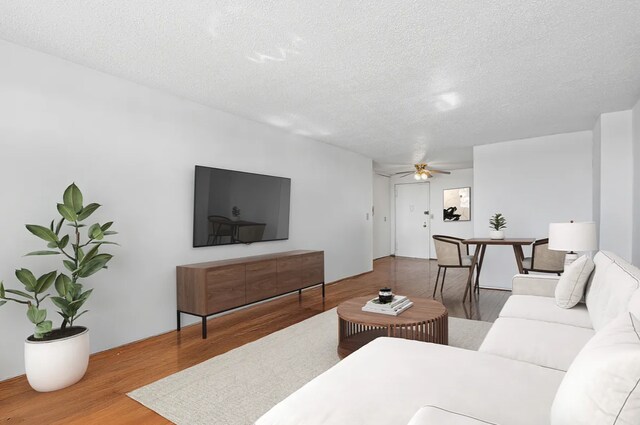 1655 Flatbush Ave Unit C2105, New York City, NY 11210 - living room with wood finished floors, a textured ceiling, and ceiling fan