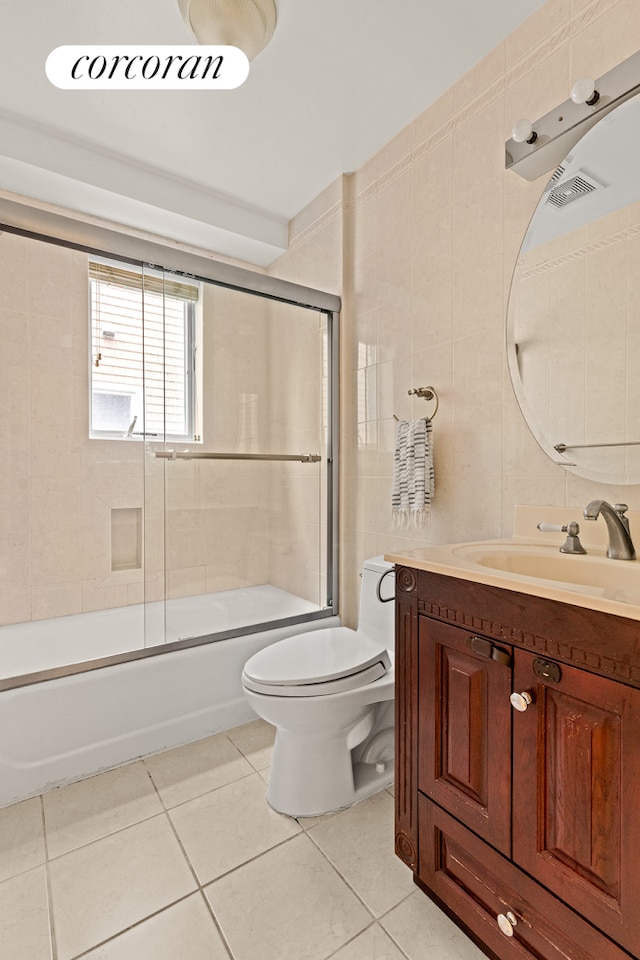 195 Bch 125th St Unit 1C, New York City, NY 11694 - full bathroom featuring tile patterned flooring, toilet, vanity, and shower / bath combination with glass door