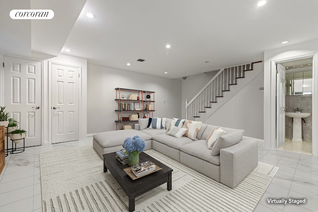 195 Bch 125th St Unit 1C, New York City, NY 11694 - living room featuring light marble finish floors, stairway, recessed lighting, and baseboards
