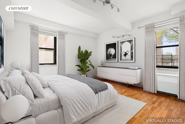 139-15 83rd Ave Unit 127, New York City, NY 11435 - bedroom with beam ceiling and light wood-style flooring