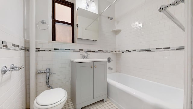 221 E 18th St Unit 1E, New York City, NY 11226 - bathroom with tile walls, vanity, toilet, shower / bath combination, and tile patterned floors
