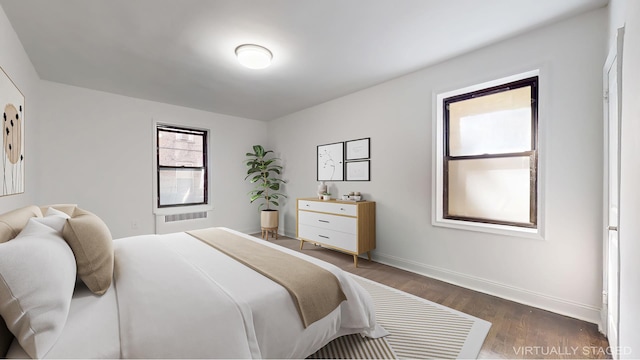221 E 18th St Unit 1E, New York City, NY 11226 - bedroom with dark wood-style floors and baseboards