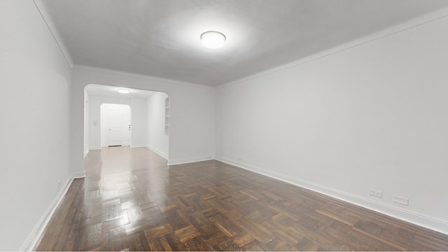 221 E 18th St Unit 1E, New York City, NY 11226 - empty room featuring arched walkways and baseboards