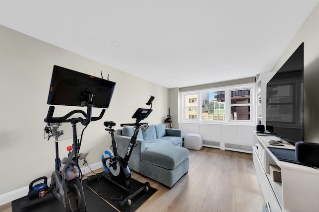 446 E 86th St Unit 7C, New York City, NY 10028 - workout area featuring light wood finished floors and baseboards