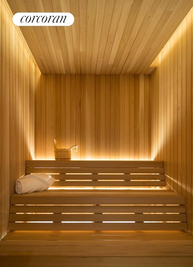 sauna with wood ceiling and wood walls