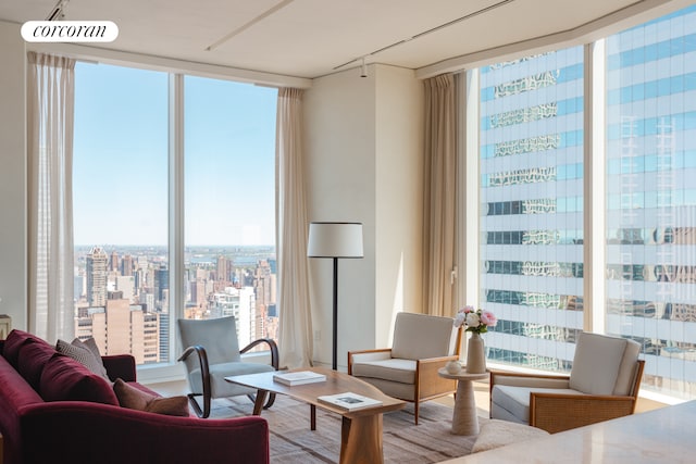 living area with a wall of windows, healthy amount of natural light, and a view of city