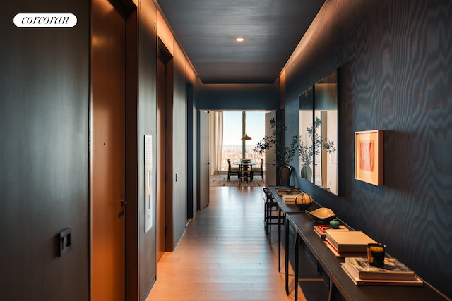 hall featuring light wood-style flooring and recessed lighting