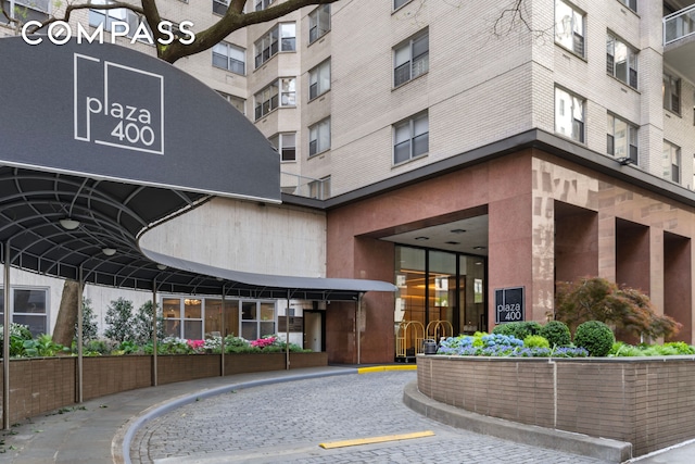 view of building exterior featuring uncovered parking