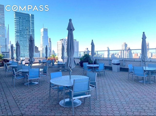 view of patio featuring a skyline view and outdoor dining area