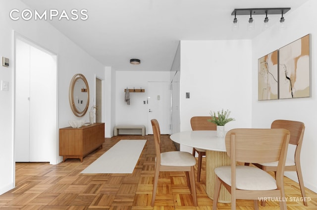 dining area featuring rail lighting