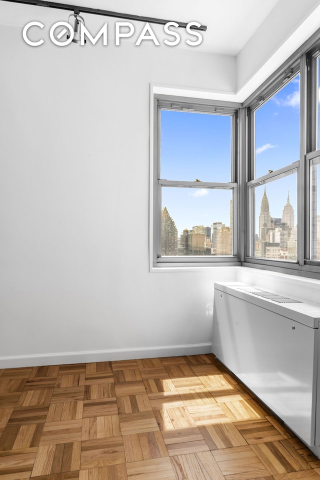 400 E 56th St Unit 38S, New York City, NY 10022 - empty room with baseboards and plenty of natural light