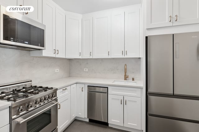 370 E 76th St Unit B1008, New York City, NY 10021 - kitchen featuring stainless steel appliances, a sink, and white cabinets