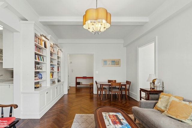 living area featuring crown molding, a chandelier, and baseboards
