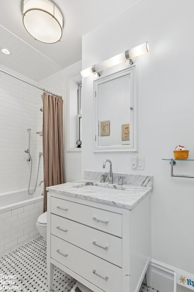 full bathroom featuring tiled shower / bath combo, toilet, and vanity