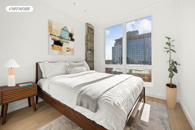 1118 Fulton St Unit 6R, New York City, NY 11238 - bedroom with wood finished floors and a city view