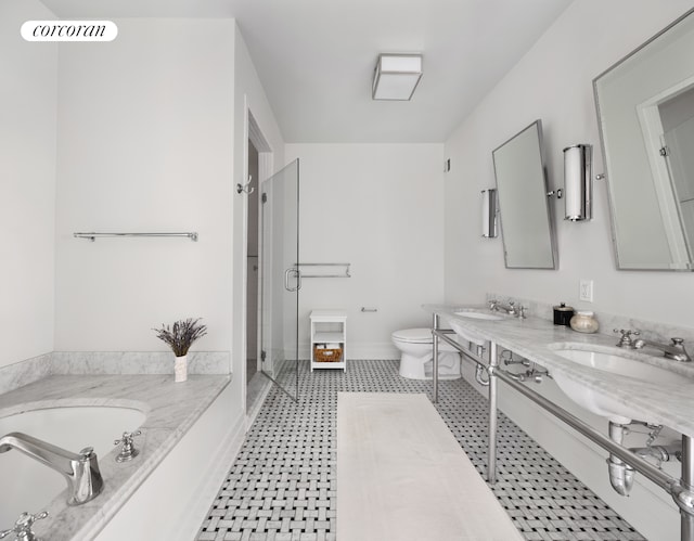 full bathroom featuring toilet, a shower stall, a bath, baseboards, and double vanity