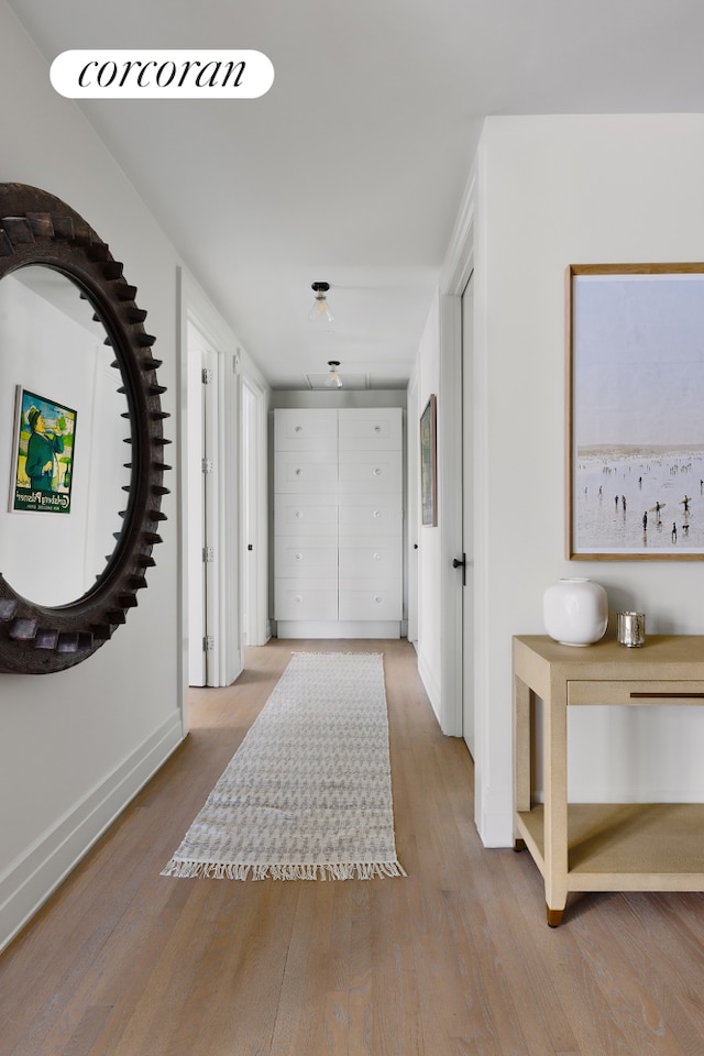foyer entrance with wood finished floors and baseboards