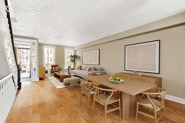 dining room with light wood-style flooring and baseboards