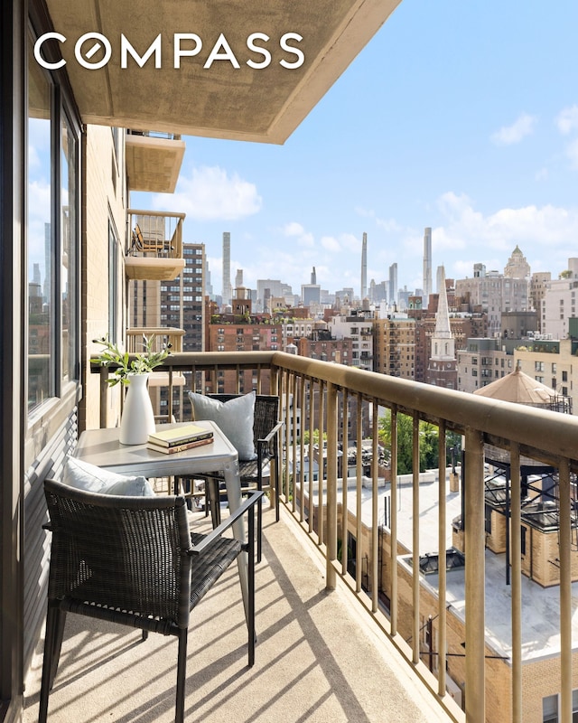 balcony featuring a skyline view