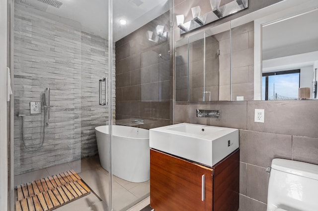 5-19 Borden Ave Unit 7-A, New York City, NY 11101 - full bath with tile walls, a stall shower, tile patterned floors, a freestanding bath, and vanity