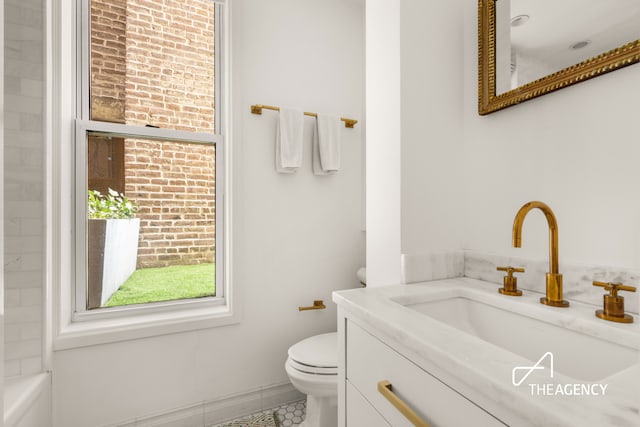 bathroom featuring toilet, tile patterned flooring, and vanity