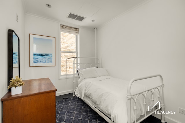 bedroom featuring baseboards, ornamental molding, and dark carpet