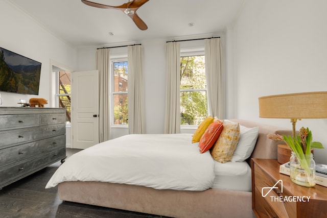 bedroom with dark wood-style floors and a ceiling fan