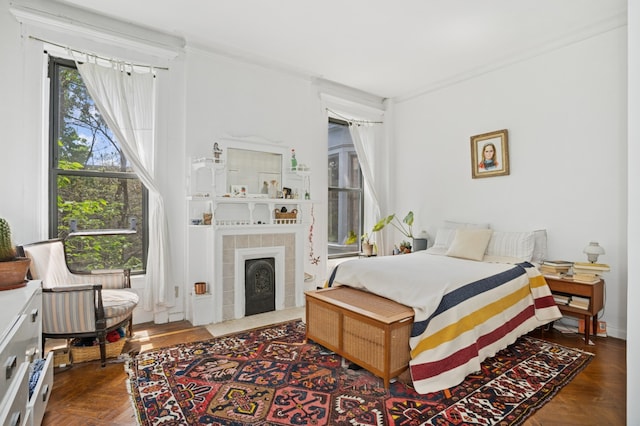 bedroom featuring a tile fireplace