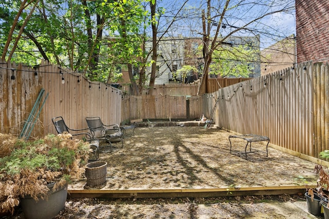 view of patio featuring a wooden deck and a fenced backyard