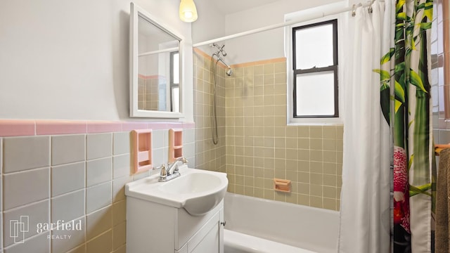 61 Oliver St Unit 2-P, New York City, NY 11209 - bathroom featuring plenty of natural light, vanity, shower / bath combo, and tile walls