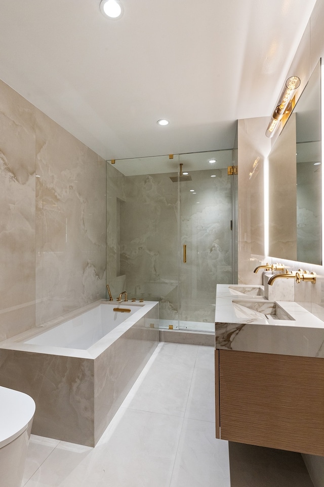full bath featuring a marble finish shower, vanity, toilet, tile patterned floors, and a garden tub