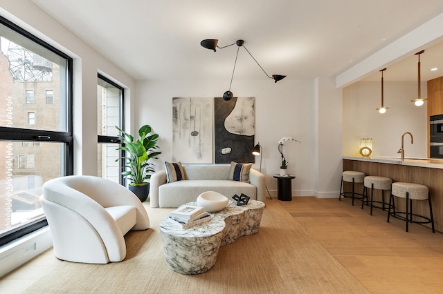 living area with wood finished floors and baseboards
