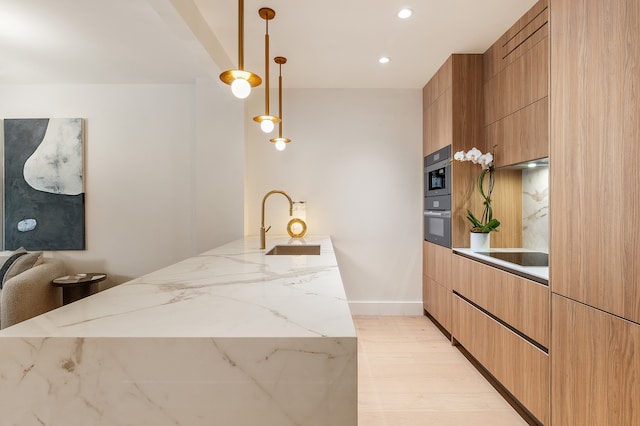 kitchen featuring a sink, modern cabinets, a peninsula, light stone counters, and recessed lighting