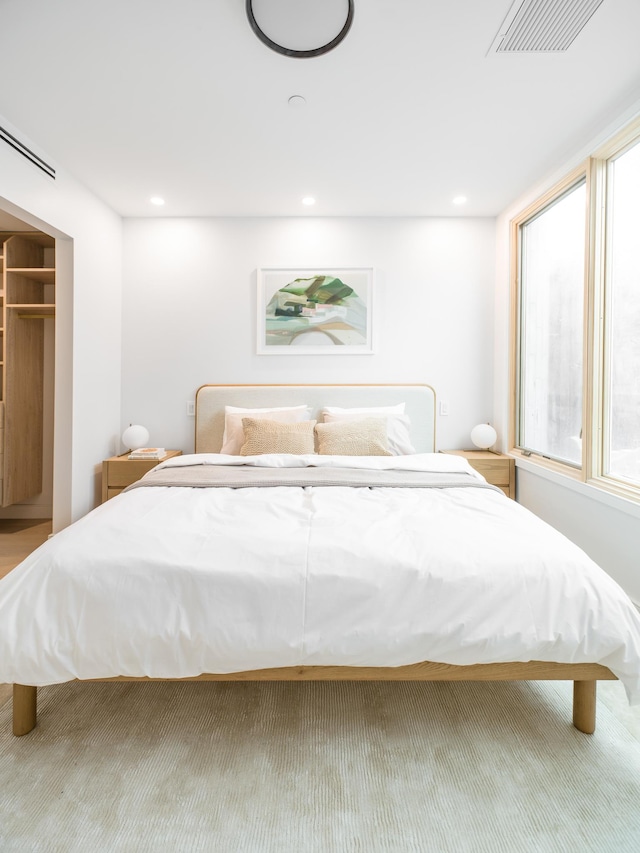 bedroom featuring multiple windows and recessed lighting