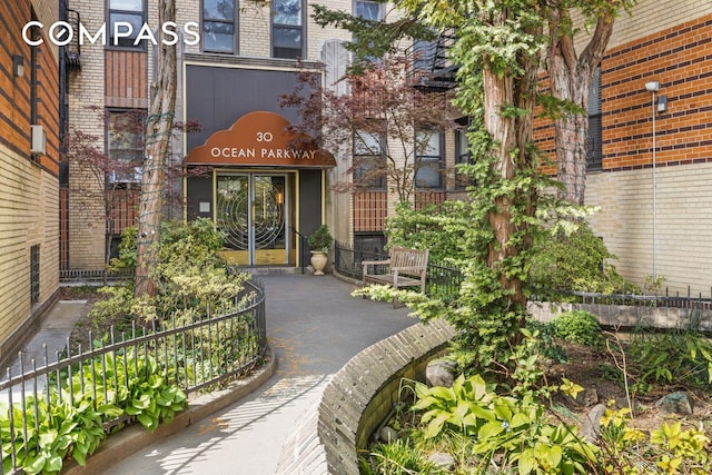 property entrance featuring brick siding